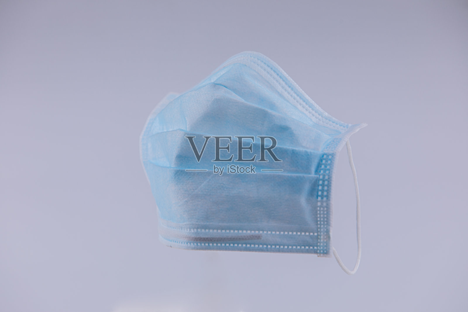 在工作室拍摄的用于防止covid-19、感冒和流感等疾病传播的医用口罩图像，背景为白色，带有遮光。照片摄影图片