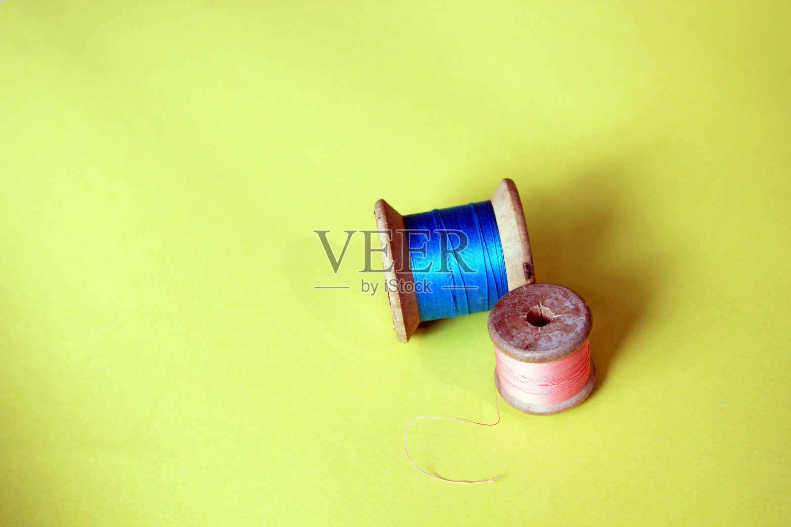 棉线轴，粉红色和蓝色，明亮的背景和复制空间照片摄影图片