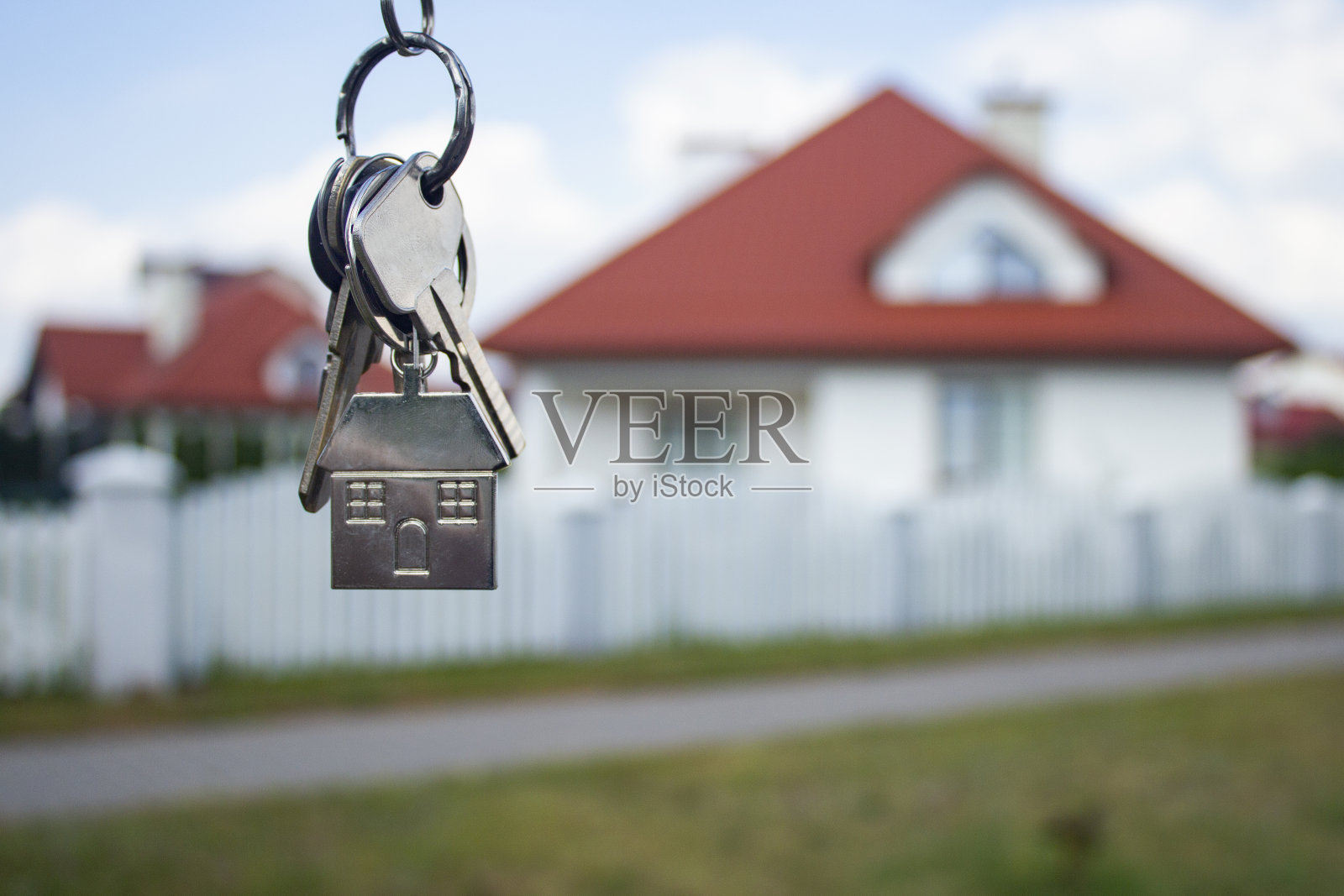 以住宅建筑为背景的新房子的金属钥匙。买房和租房的概念。照片摄影图片