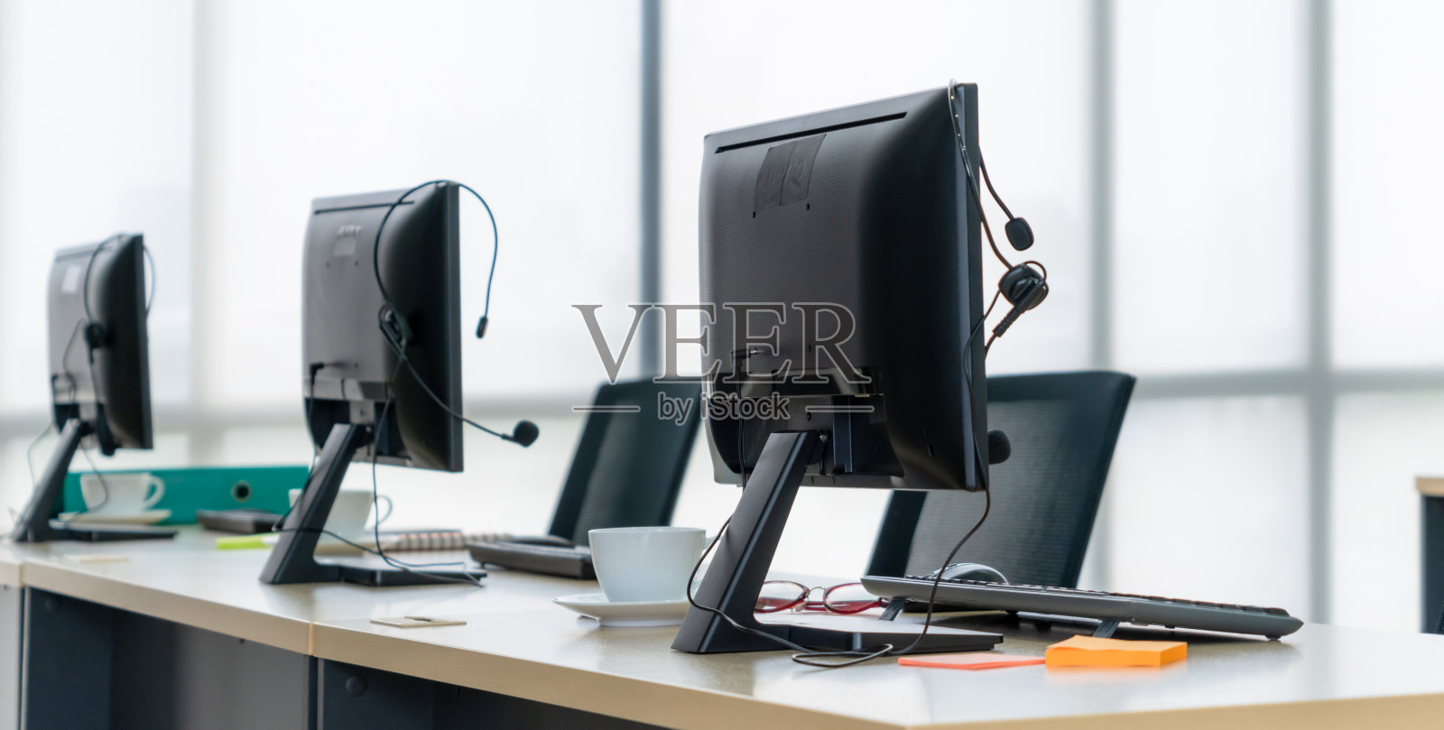 办公室里都有呼叫中心的电脑和耳机照片摄影图片