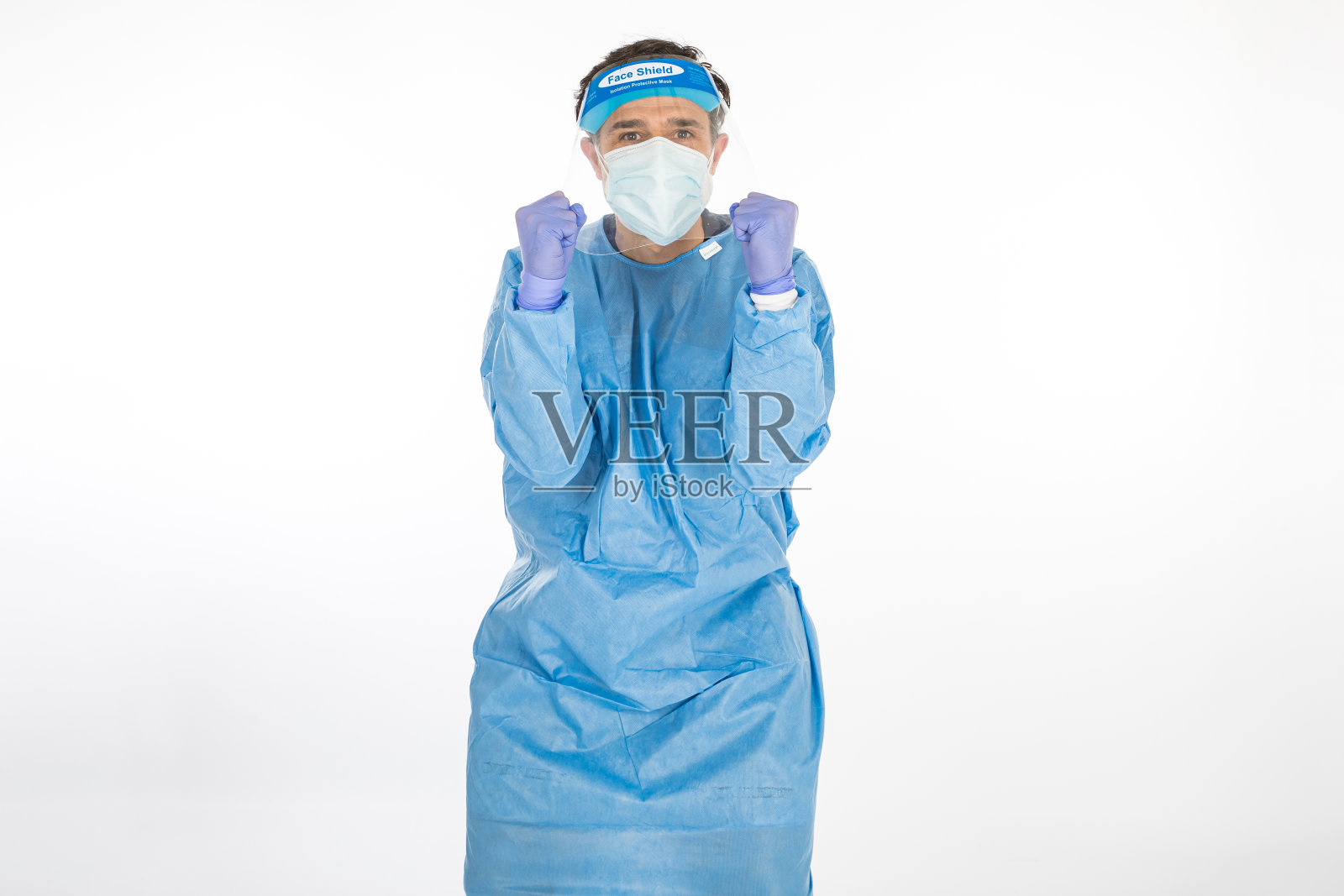 医生穿着蓝色PPE抗击冠状病毒，准备战斗，白色背景。战士。COVID医学概念照片摄影图片