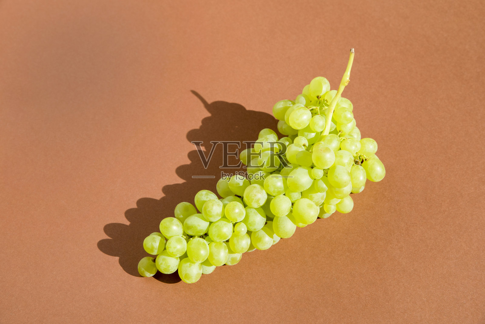 棕色背景上的葡萄。一群人。照片摄影图片