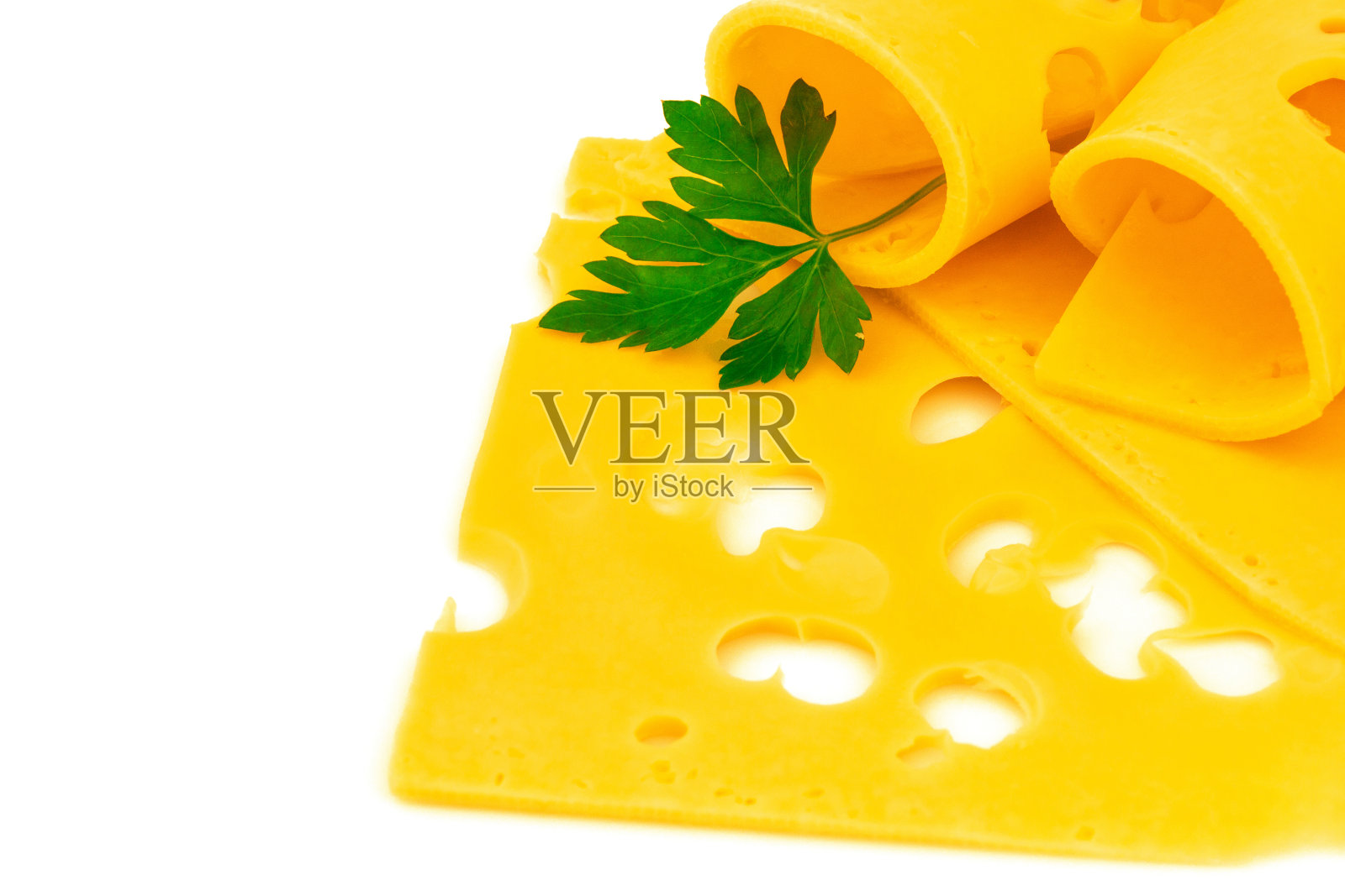 卷薄的硬黄色奶酪片，有洞和欧芹在白色的背景照片摄影图片