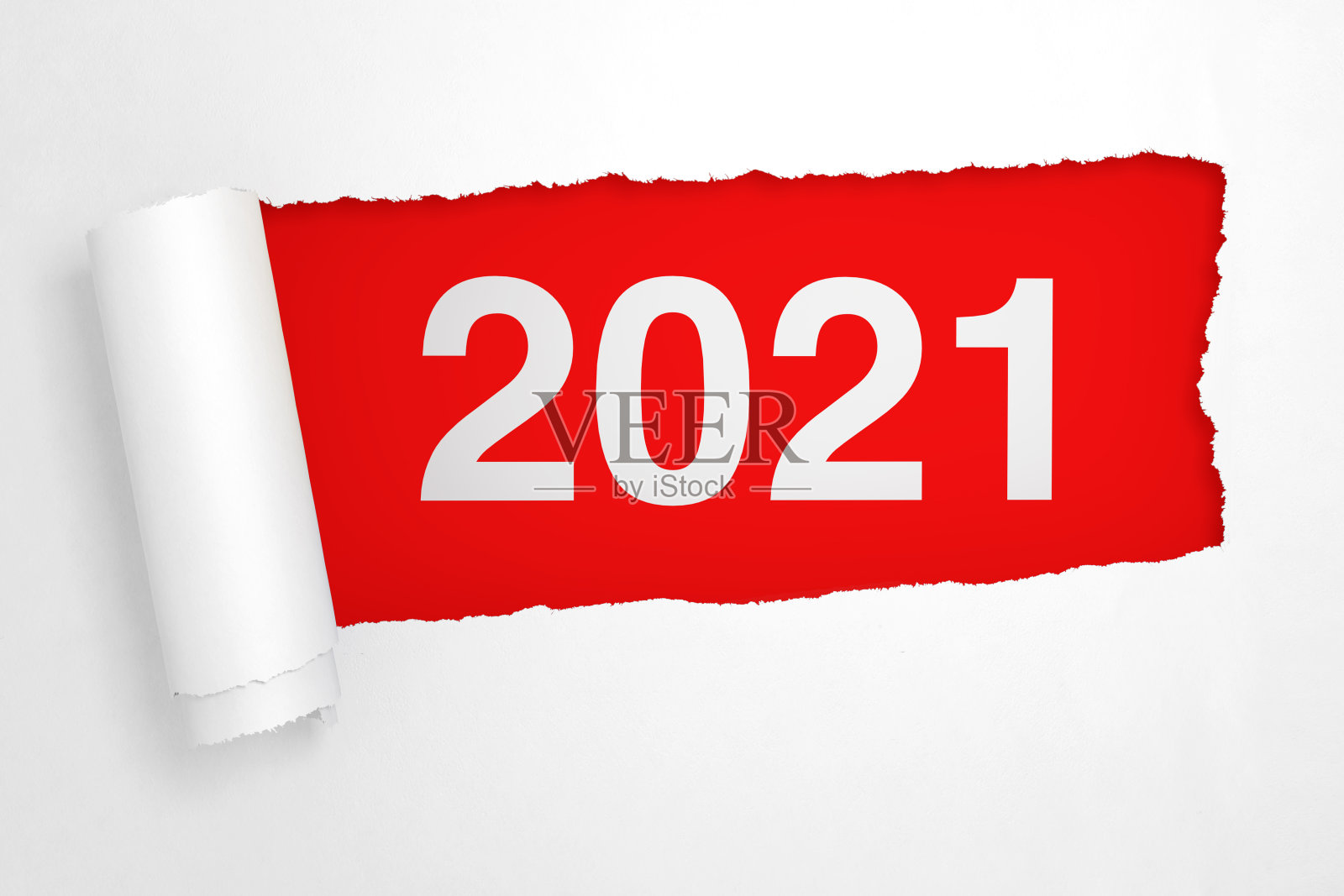 在撕破的白纸洞里的2021年新年标志照片摄影图片
