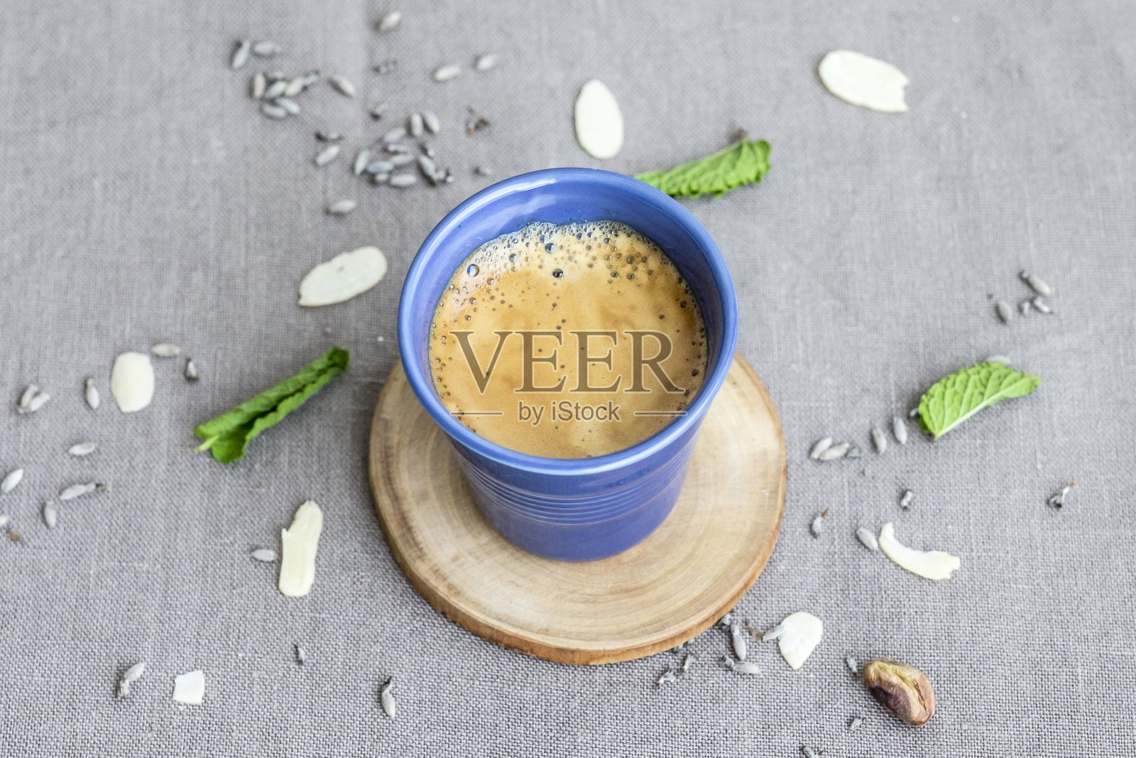 桌上放着一杯咖啡，蓝色杯子里装着一杯浓缩咖啡照片摄影图片