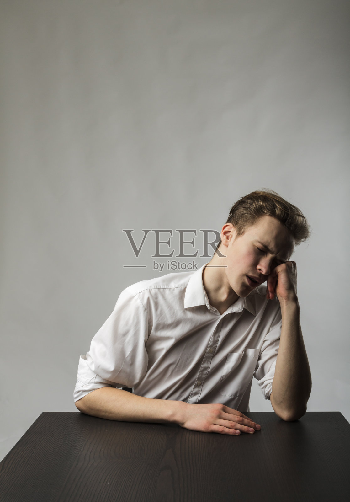 累的年轻人。加班和疲劳的概念。照片摄影图片