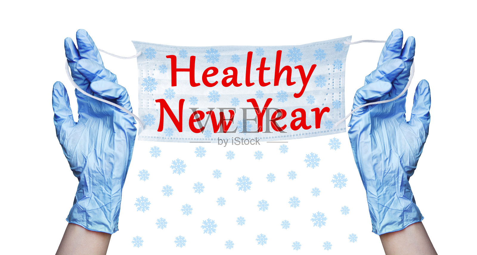 双手戴着蓝色橡胶医疗手套，外科防护口罩，雪花图案，健康新年文字白色背景隔离特写，冠状病毒防护，圣诞节日横幅，快乐2021照片摄影图片