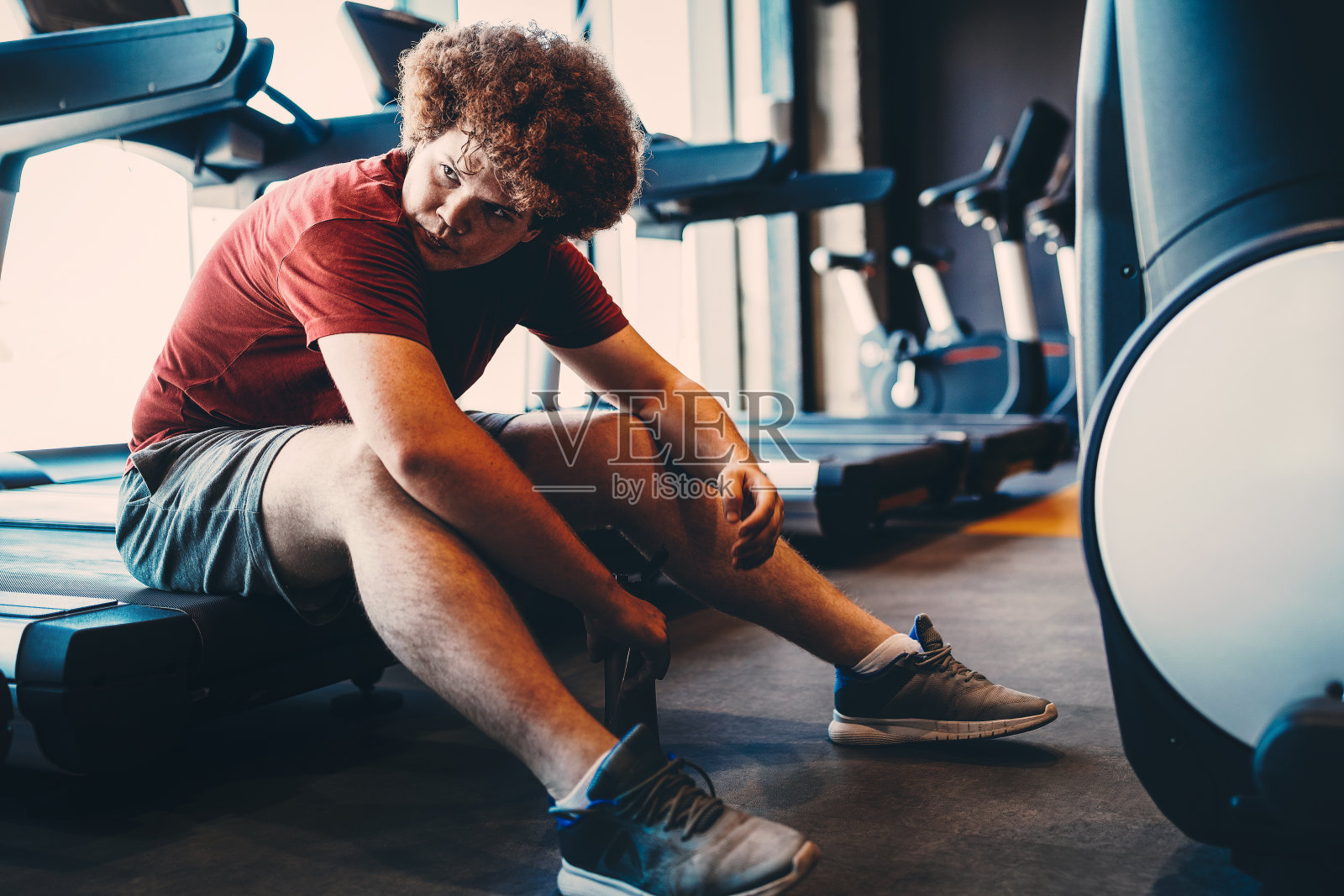 疲惫的胖子思考体重问题，渴望减肥，去健身房锻炼照片摄影图片