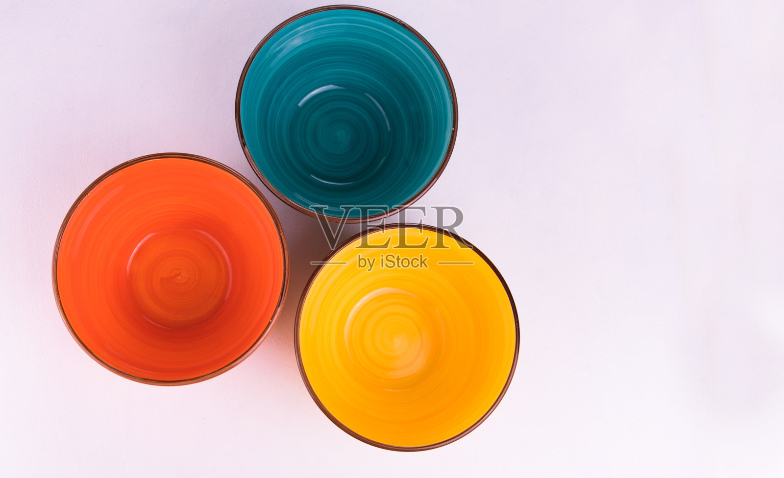 白色背景上的三只五颜六色的碗。从上面看。副本的空间。照片摄影图片