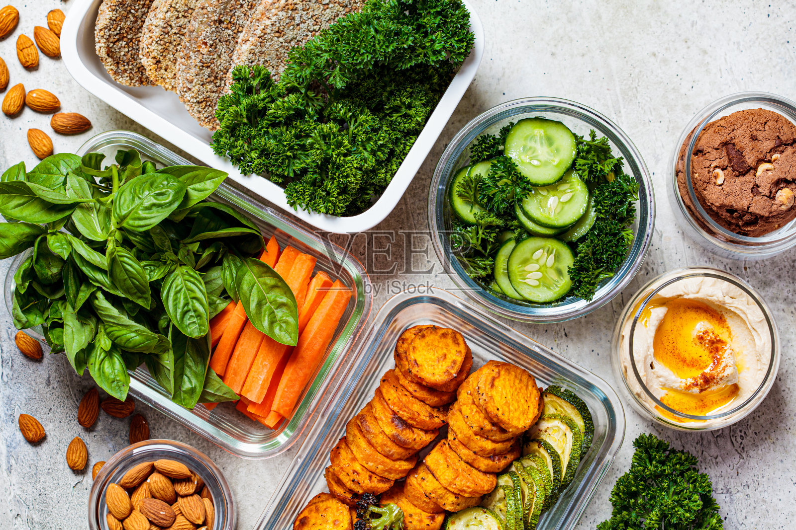 为这周准备健康食物，俯视图。灰色背景的容器中的素食食品和健康零食。照片摄影图片