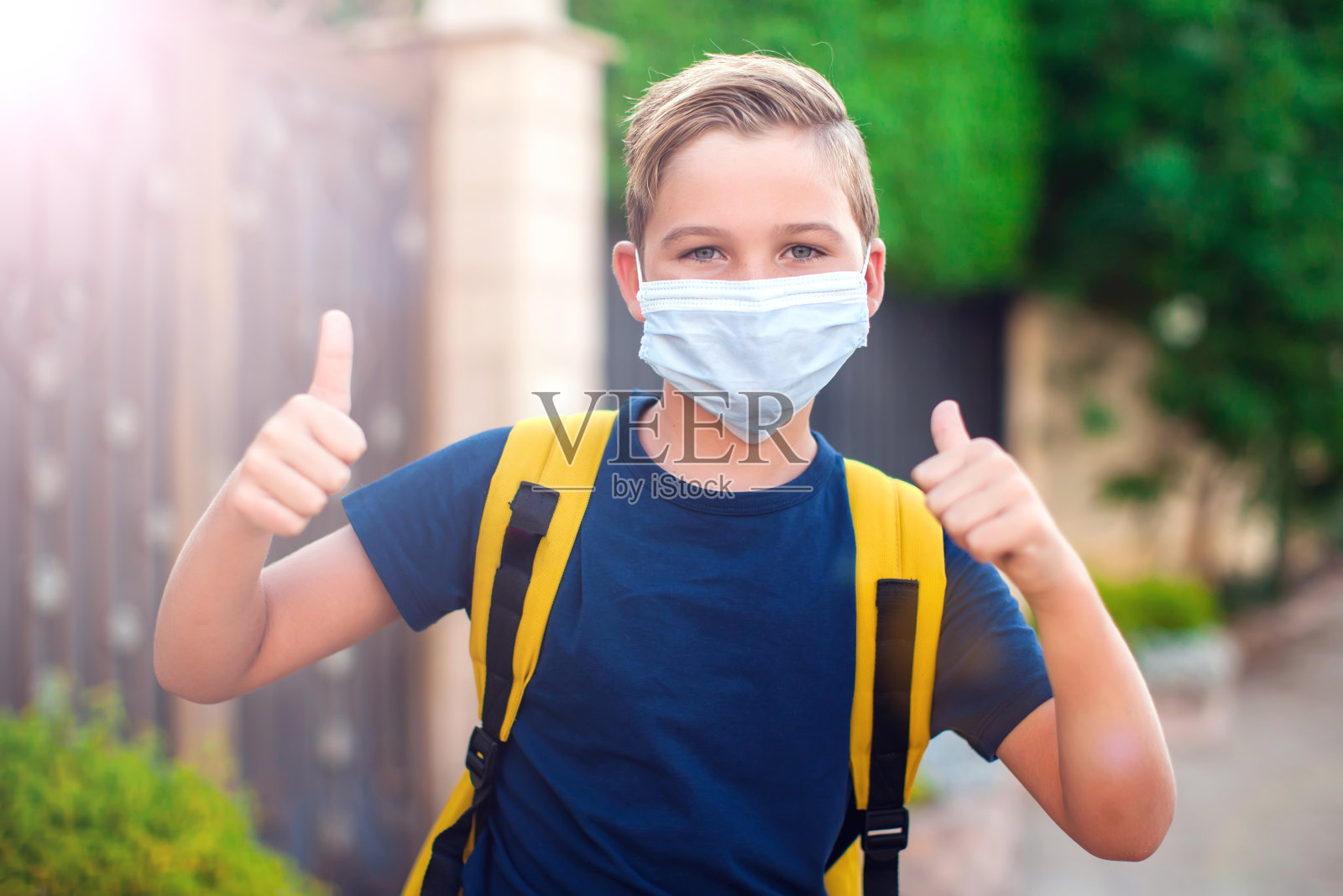 戴口罩的学生待在户外。回到学校。冠状病毒保护照片摄影图片