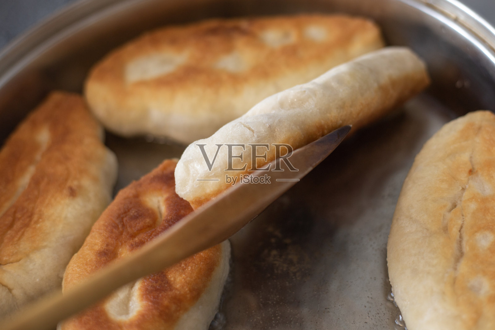 用植物油在平底锅里煎馅馅饼照片摄影图片