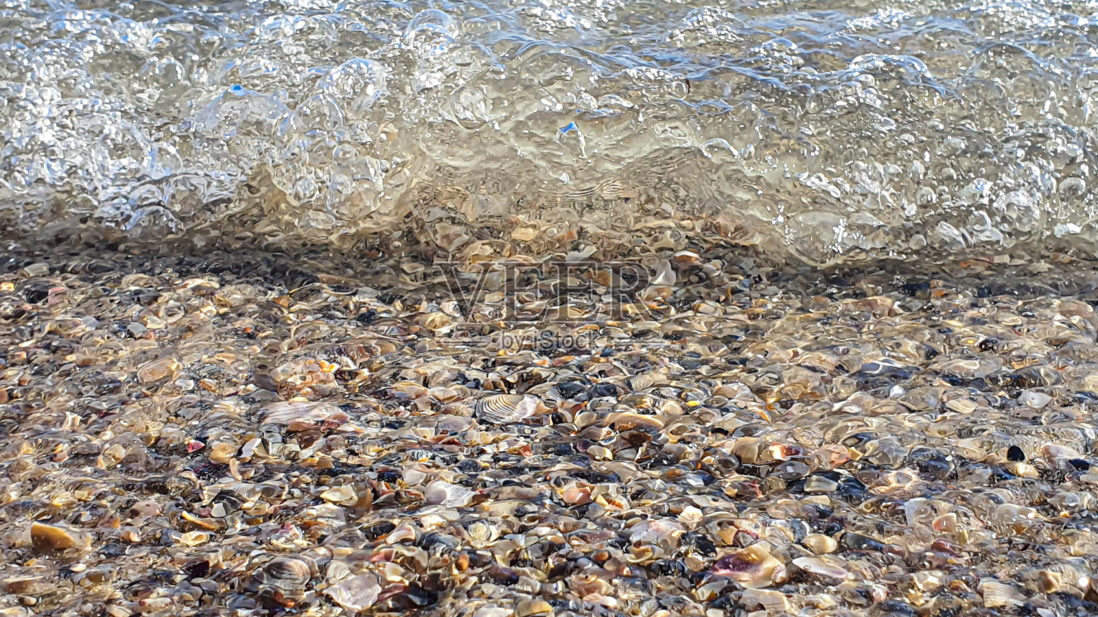 海景。碧蓝的水，浪花在岸边泛起泡沫。有选择性的重点。夏天休息。照片摄影图片