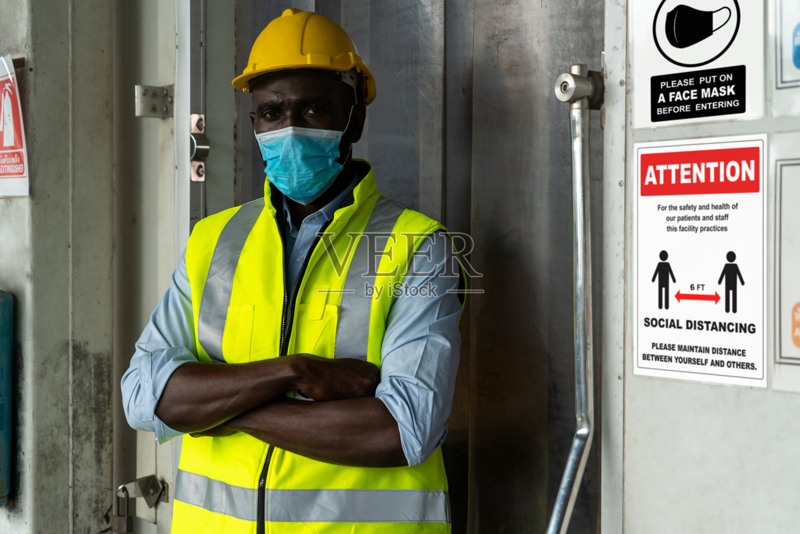 工厂里的警示标志提醒产业工人预防Covid-19照片摄影图片