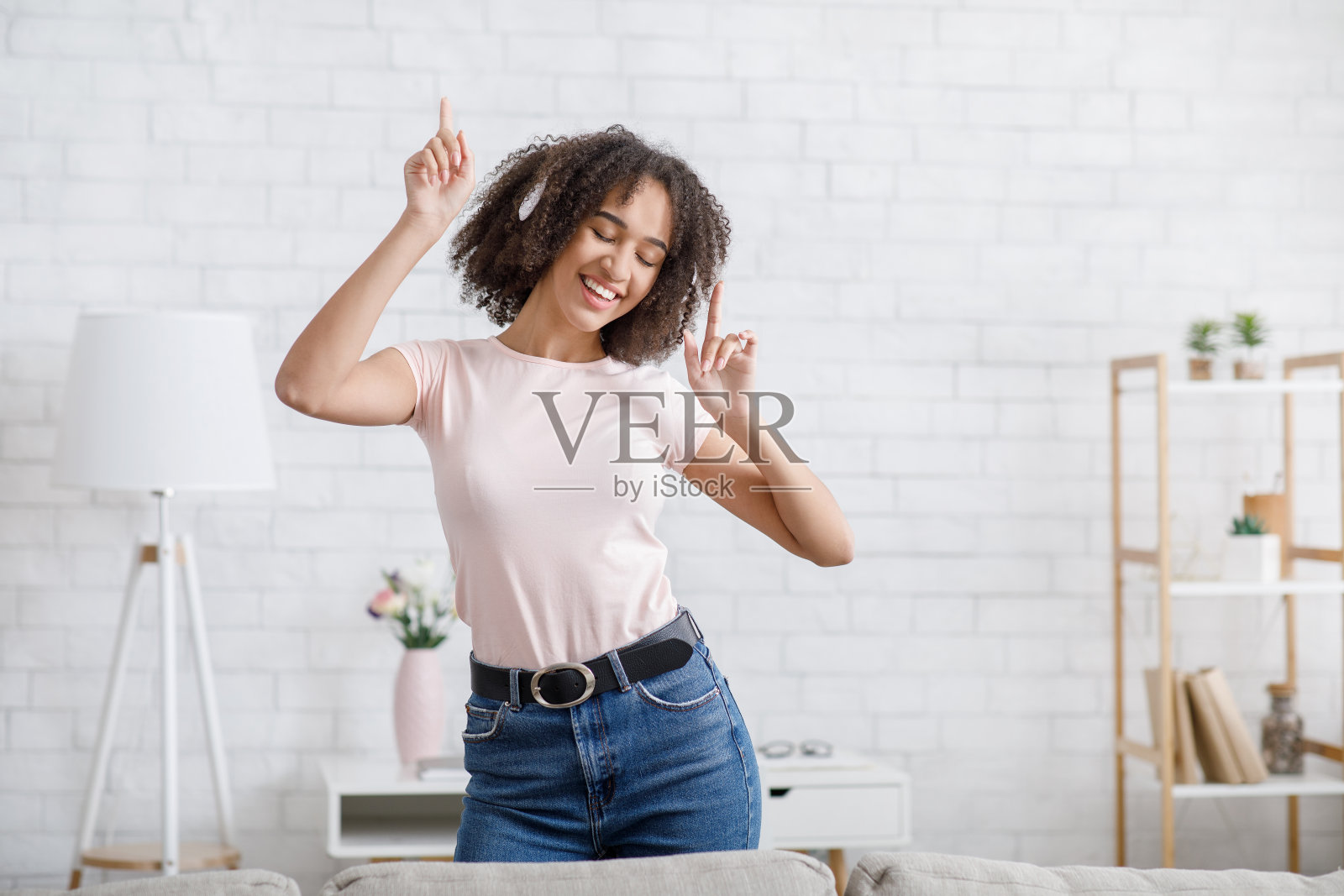 一个人在家跳舞真有趣。女孩戴着耳机在客厅里演奏音乐照片摄影图片