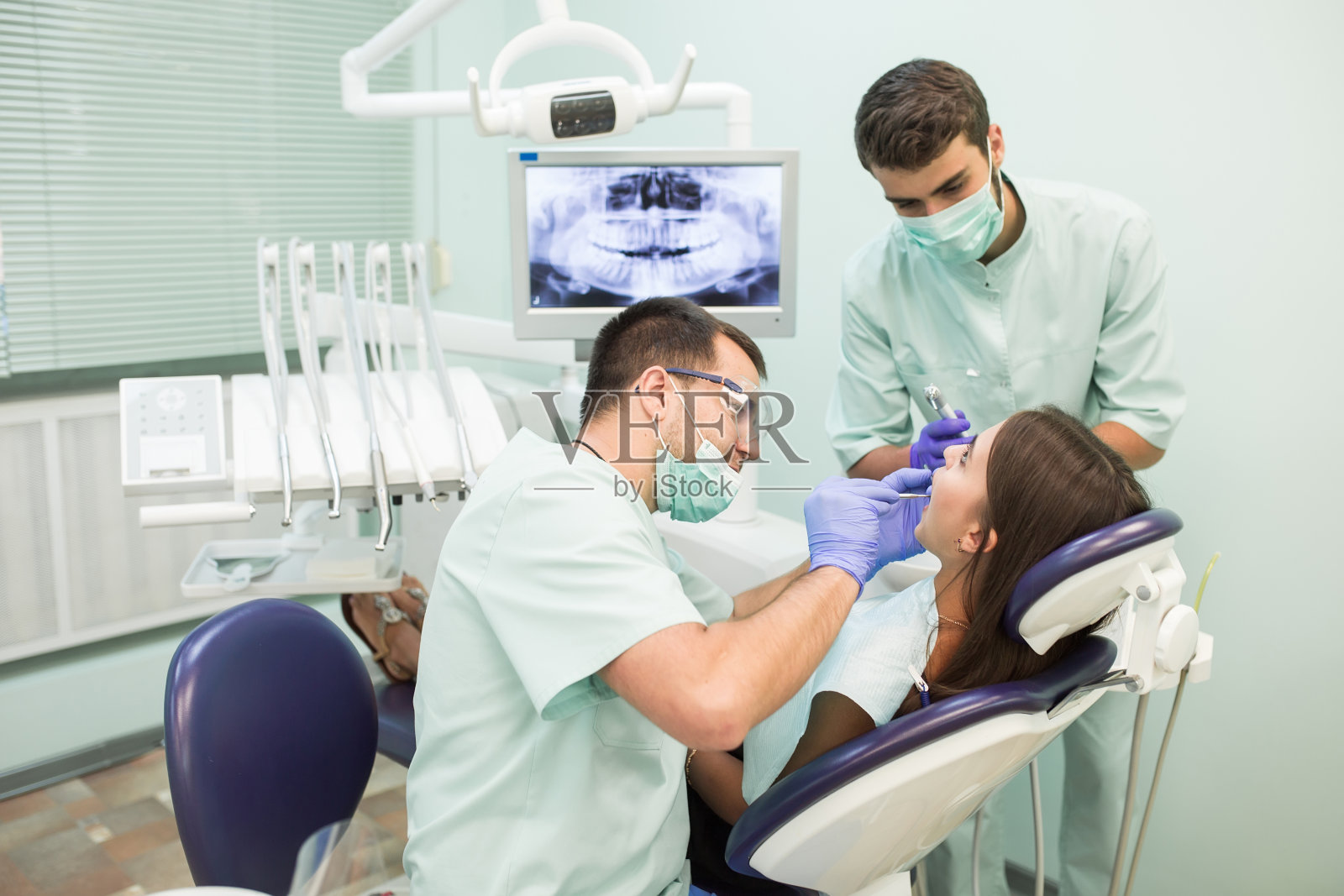 牙医在牙科诊所有一名助手照片摄影图片