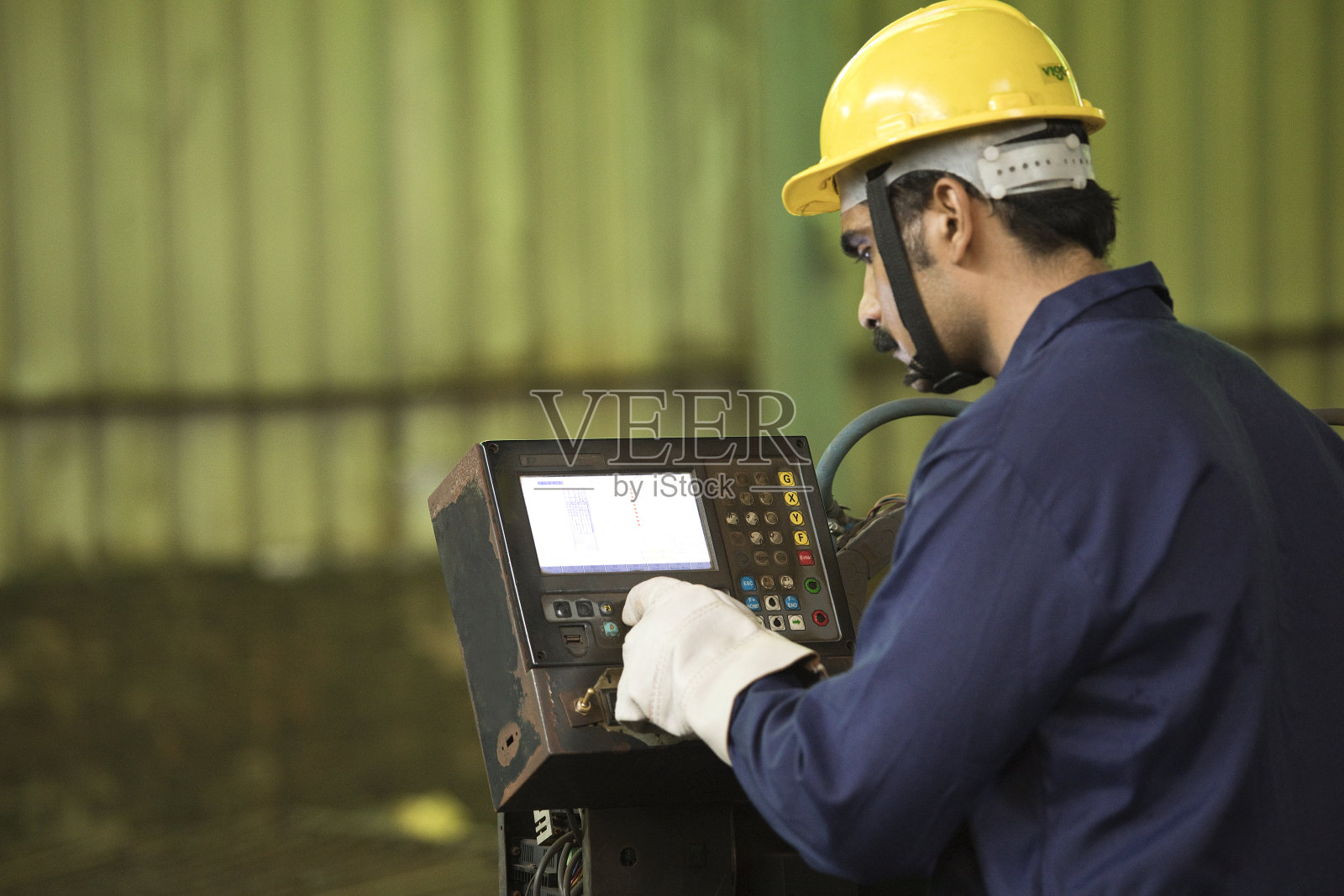 机械师在工厂操作机器照片摄影图片