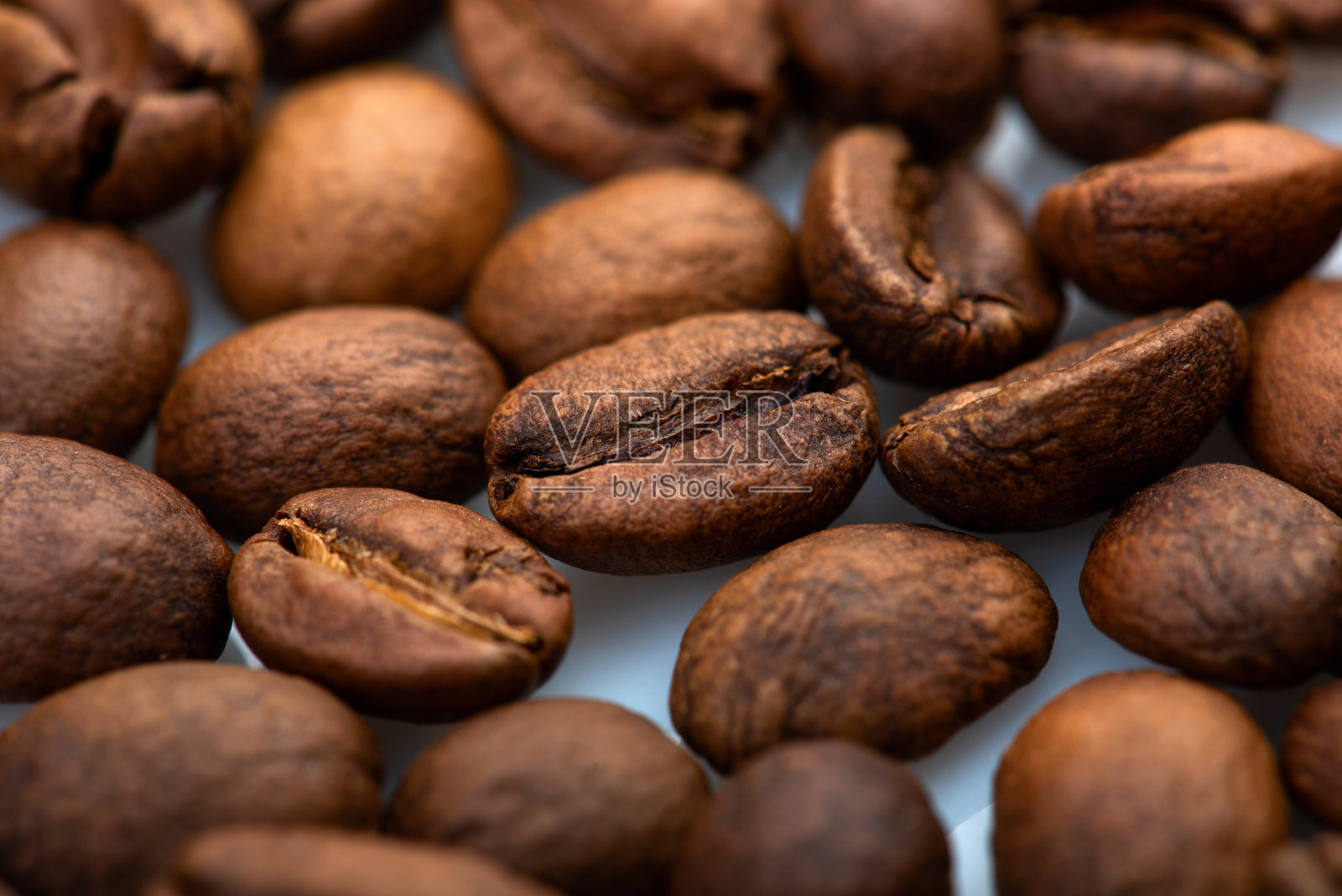 咖啡豆特写背景。新鲜的烤照片摄影图片