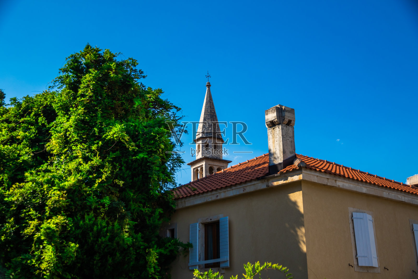 从树后看教堂景色优美，构图正确，天晴，布瓦黑山照片摄影图片