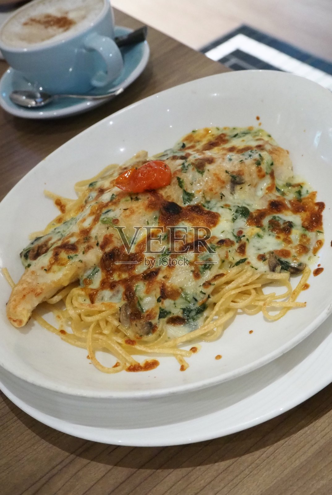 烤扁面配煎鱼片，加菠菜奶油及芝士照片摄影图片