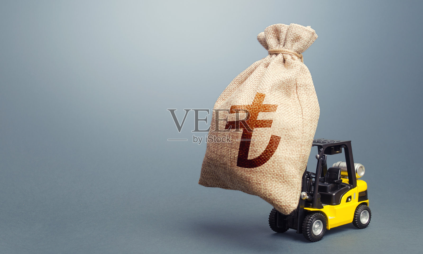 带着土耳其里拉钱袋的叉车。强有力的财政援助，商业支持。刺激经济。应对危机的预算。资本市场借款。软贷款补贴。照片摄影图片