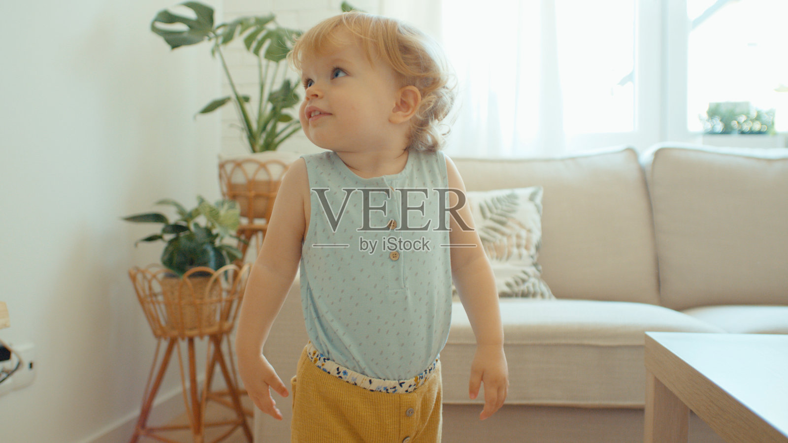 年轻可爱的金发小女孩在家玩得很开心。照片摄影图片