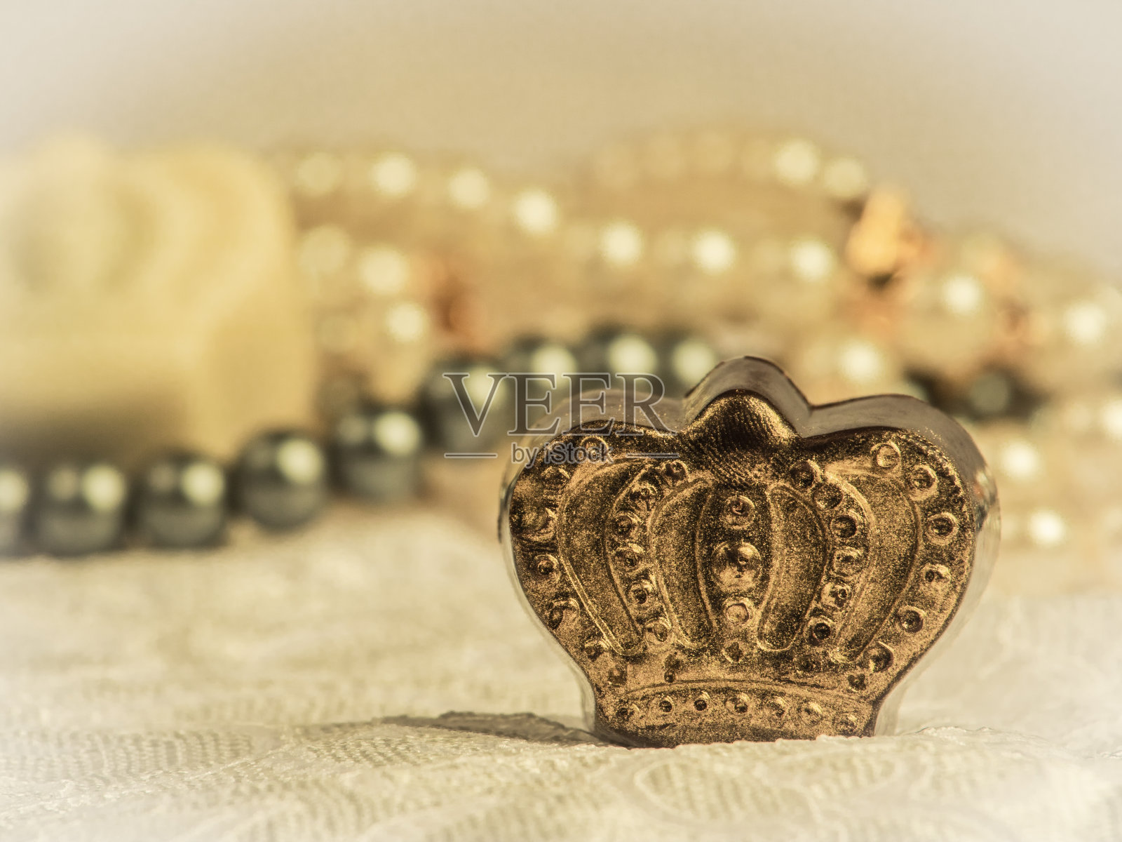 近距离聚焦拍摄皇室主题的巧克力糖果和珍珠项链照片摄影图片