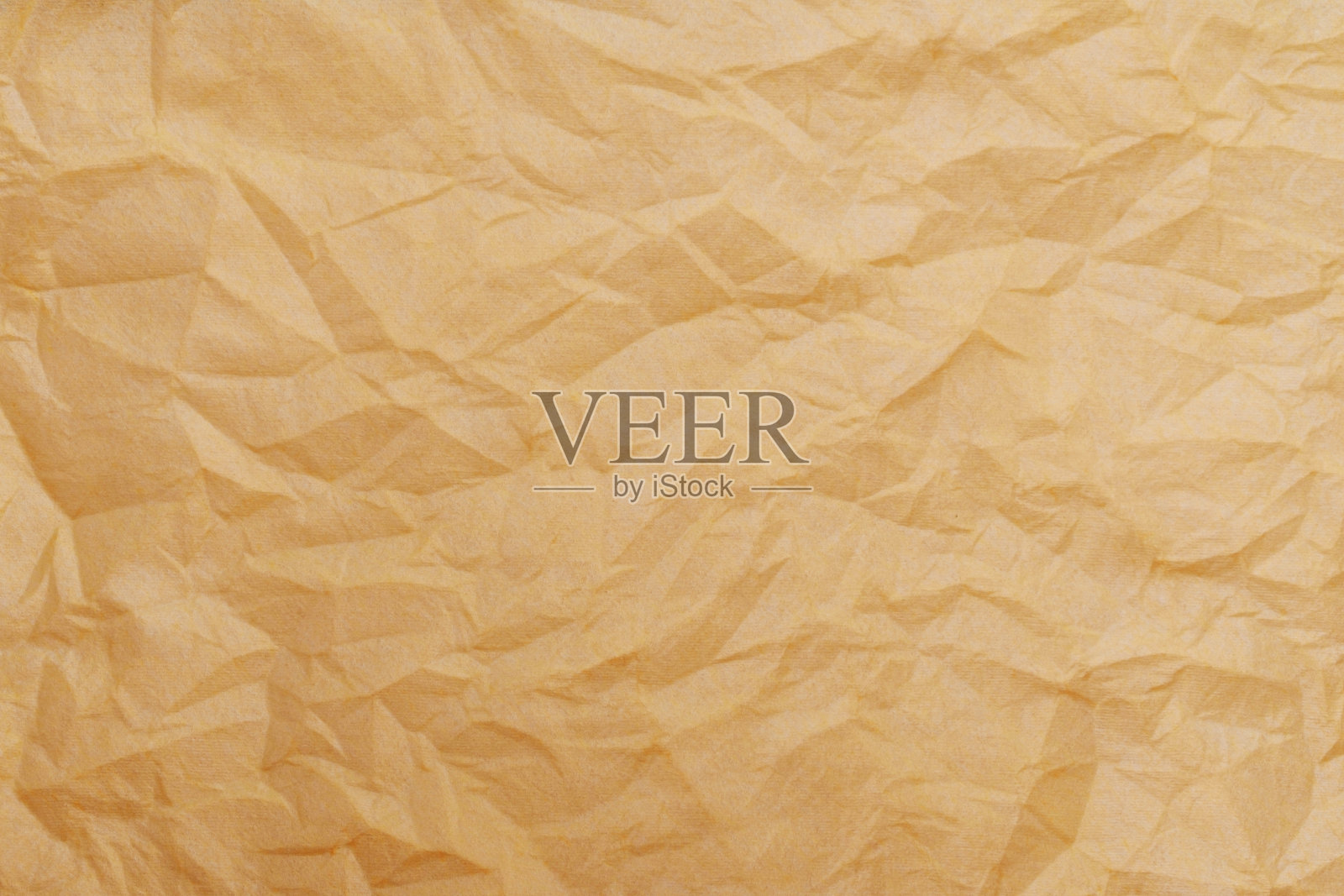 一种皱巴巴的金黄色一次性纺织餐巾的质地。照片摄影图片