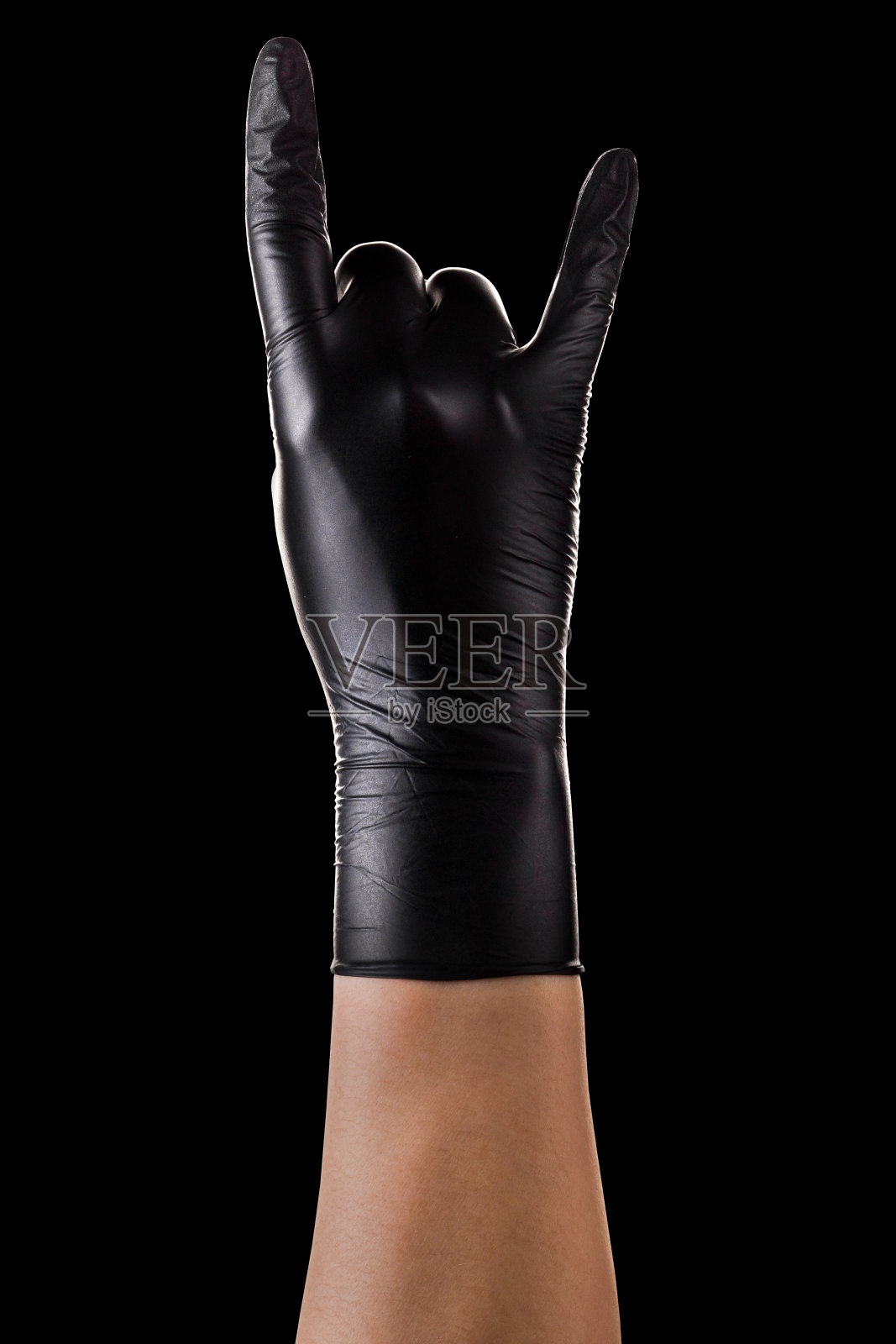 手在黑色手套显示摇滚标志或给魔鬼角手势照片摄影图片