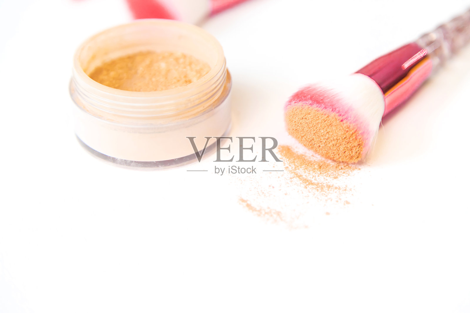 在白色的背景上使用化妆刷和粉末。有选择性的重点。照片摄影图片