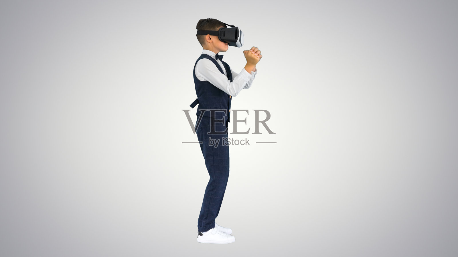 穿着正式的男孩在虚拟现实gog玩剑游戏照片摄影图片