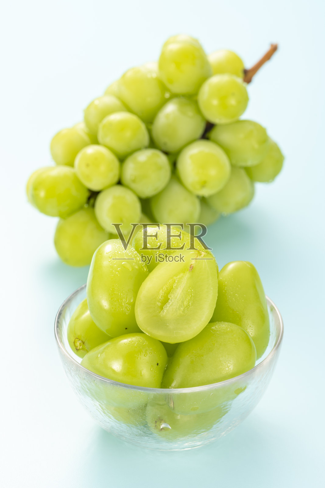 淡蓝色背景的马斯喀特。夏天的水果。照片摄影图片