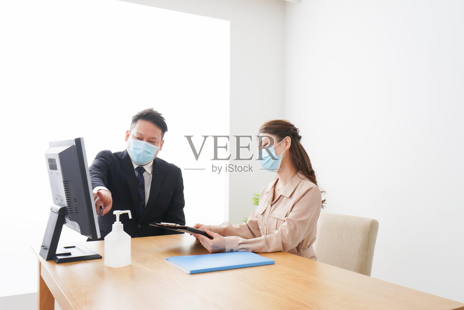 戴口罩在办公室工作的商务人士照片摄影图片