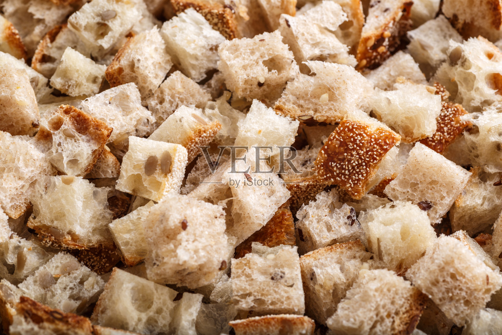 新鲜烘焙的黑麦面包与麸皮和谷物种子:纹理特写。健康食品。干面包屑照片摄影图片