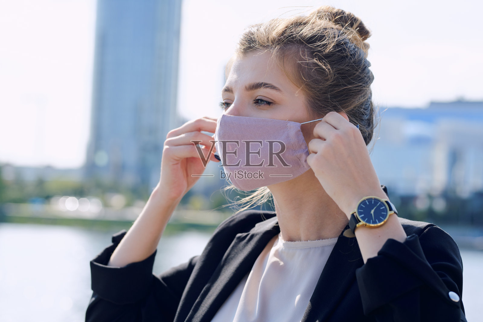 年轻优雅的女商人穿着正装，戴上防护面具照片摄影图片