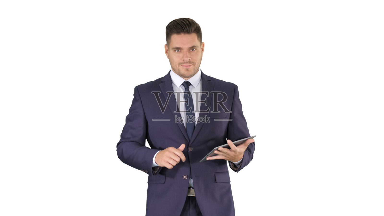 一个商人在他的平板电脑上行走并滑动页面，看着相机在白色背景上呈现一些东西照片摄影图片