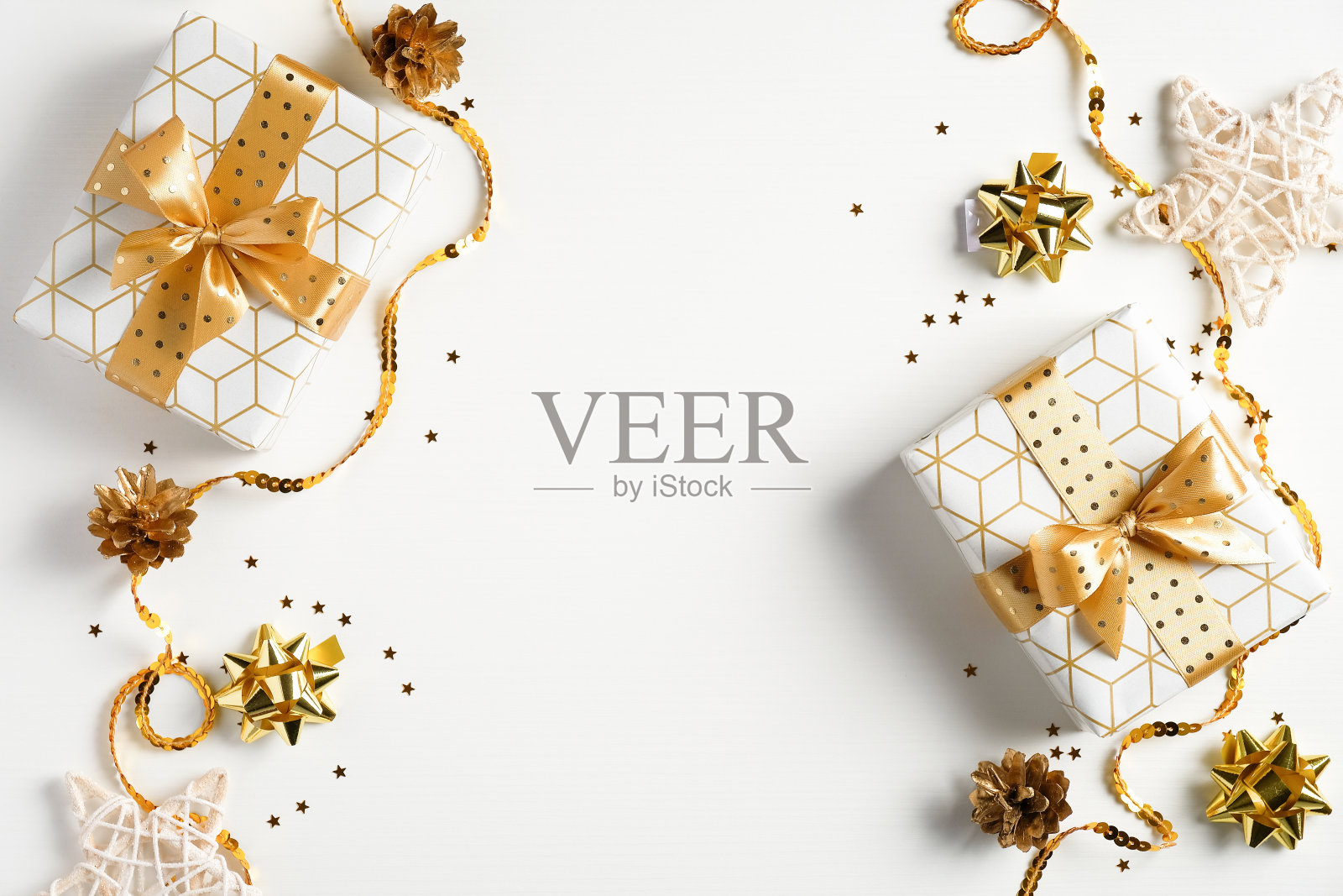 平躺圣诞作文。俯视图礼盒，金色装饰，丝带，纸屑在白色背景。圣诞节、寒假、新年概念照片摄影图片
