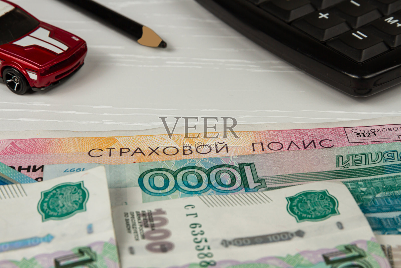 保单和钱躺在一张白色的桌子上刻有保单的字样照片摄影图片