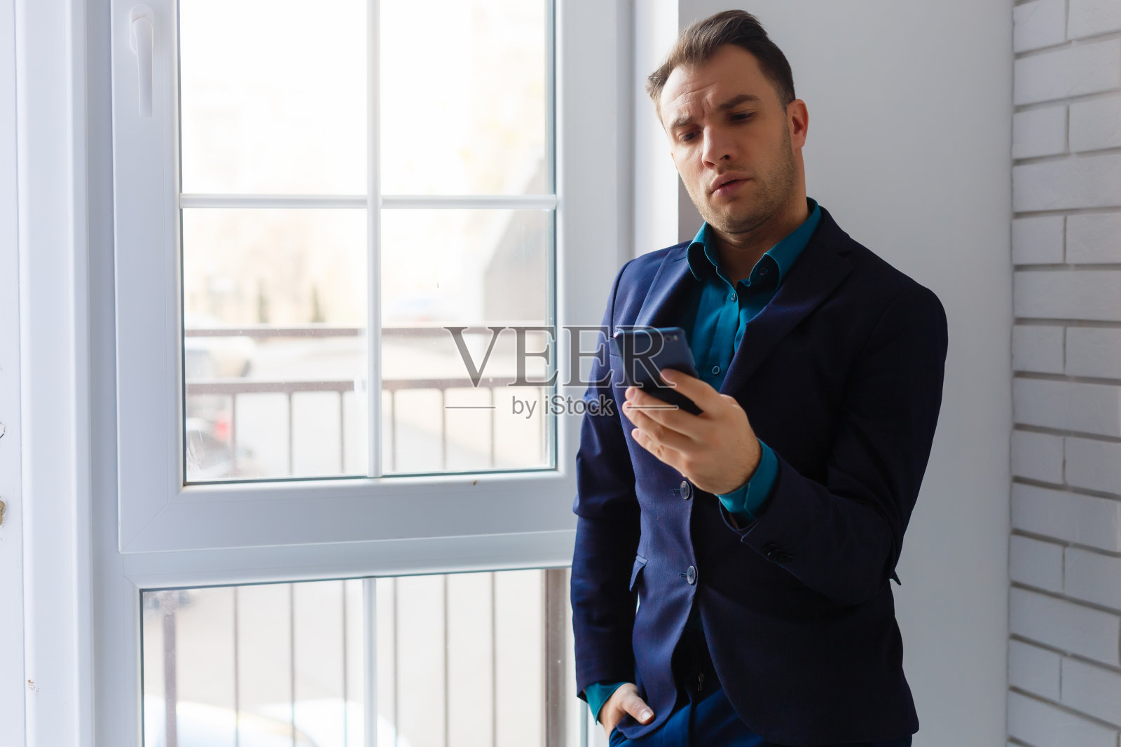 一个年轻人站在空办公室的包裹旁边的肖像照片摄影图片