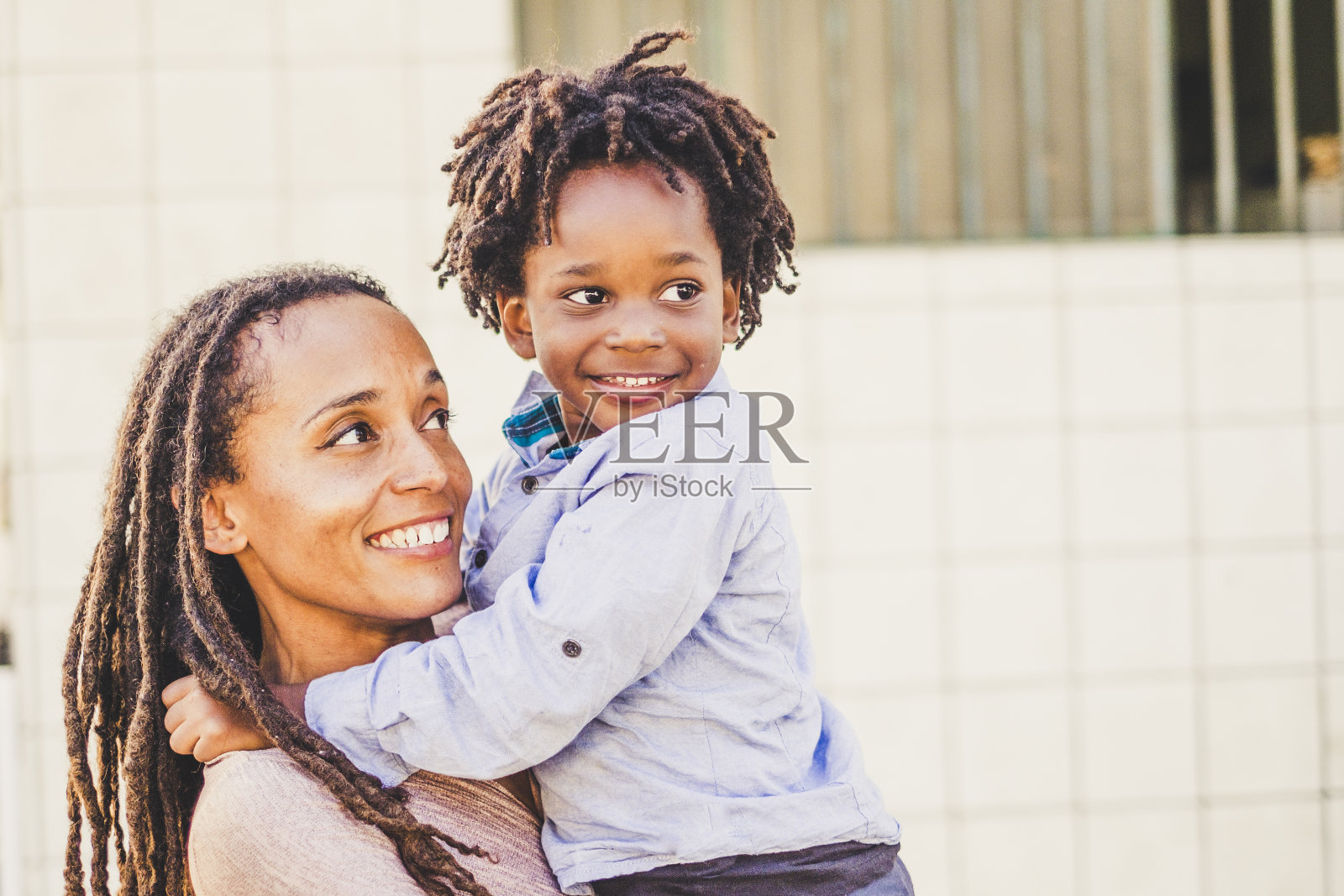 快乐的黑人母子在城市里享受户外休闲活动——单身母亲和小孩子微笑——有趣的家庭爱心概念照片摄影图片