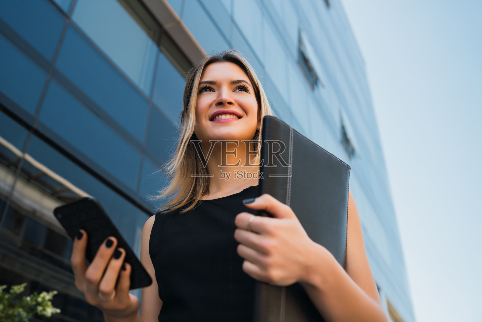 商务女性使用手机。照片摄影图片