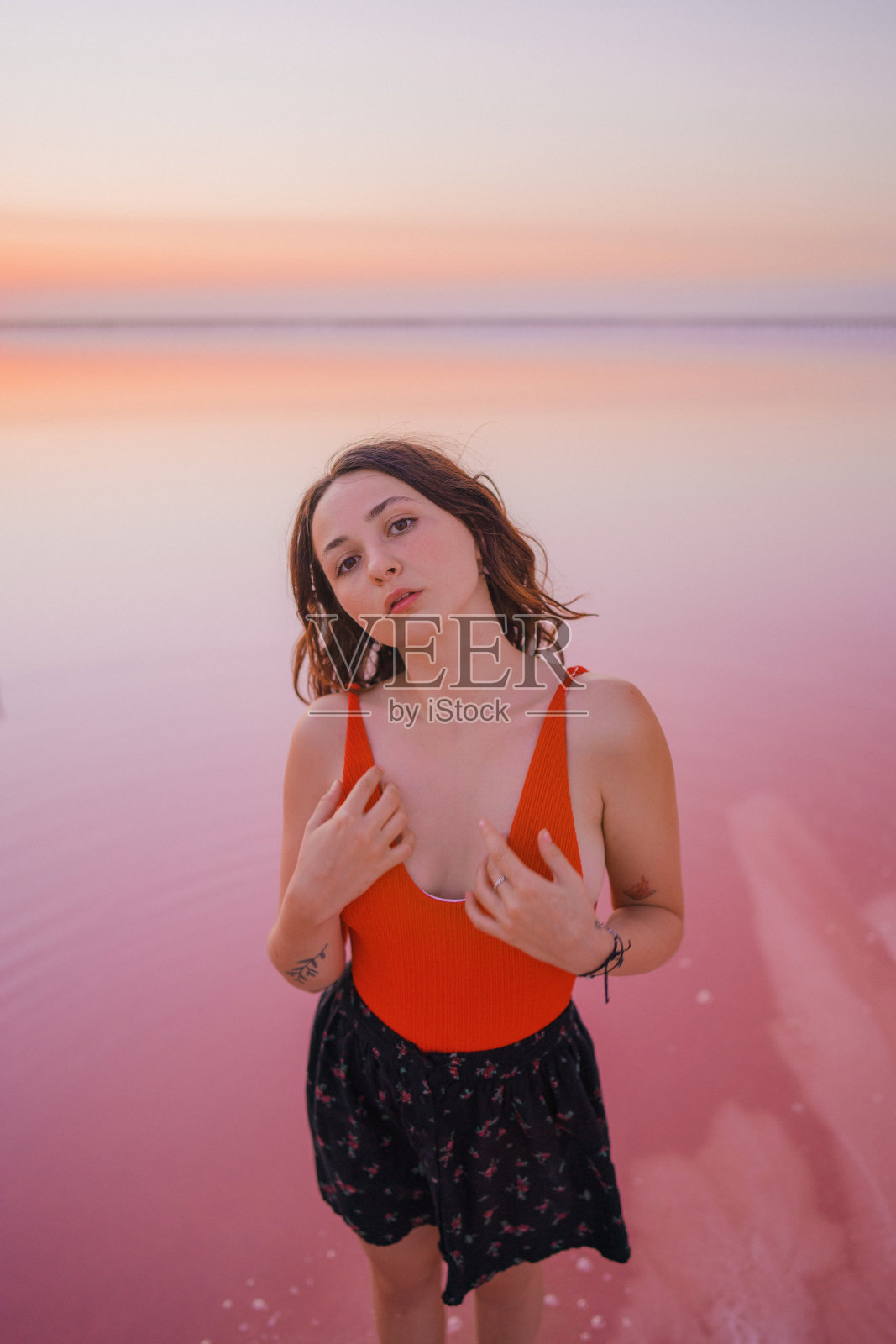 一名女子走在乌克兰的粉色盐湖上照片摄影图片