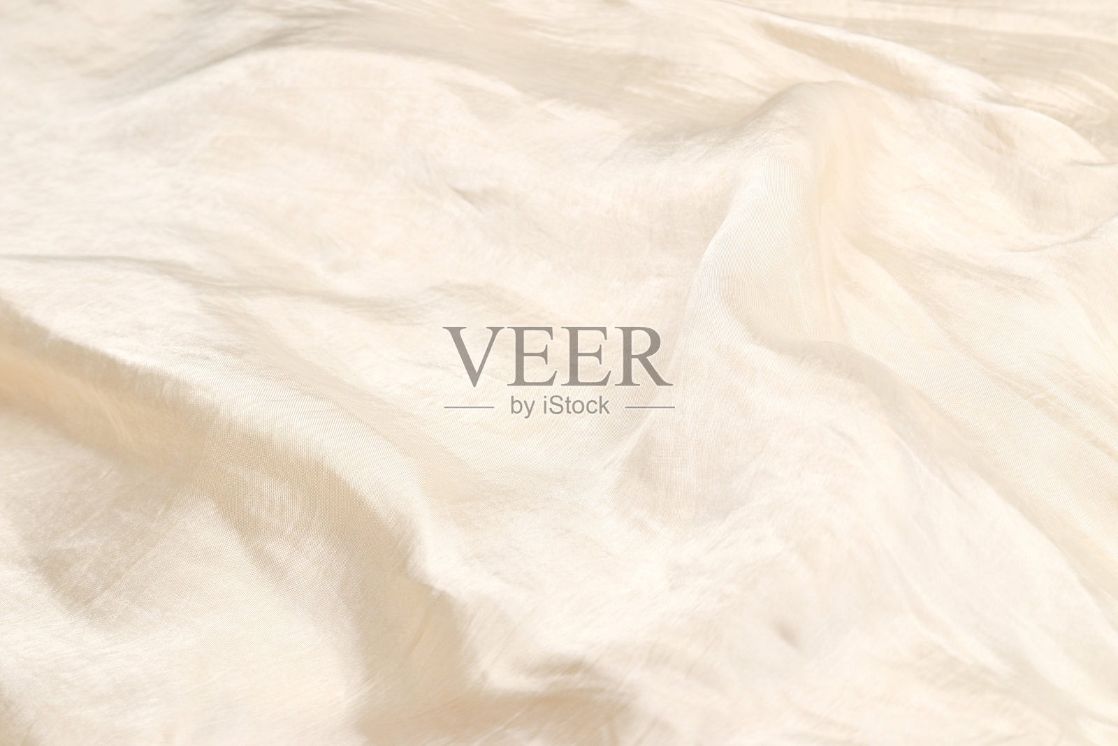 柔软光滑的米色丝质面料背景。面料质地。照片摄影图片