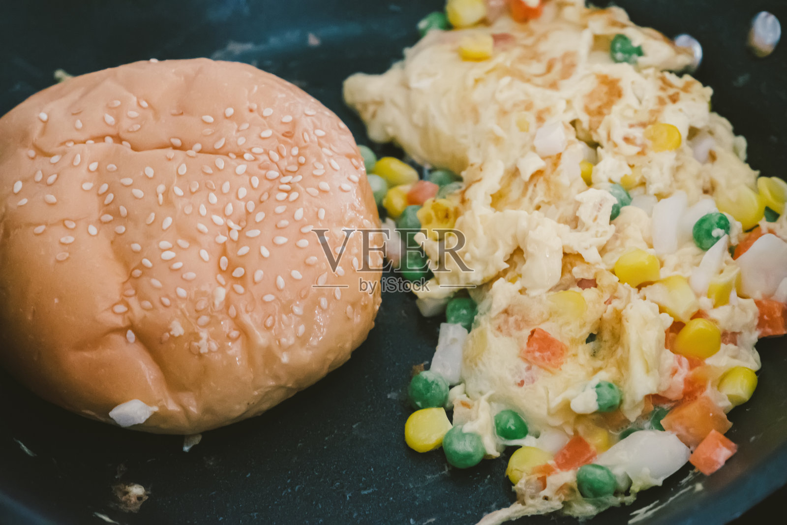 煎蛋和汉堡粉在黑色平底锅里煎照片摄影图片