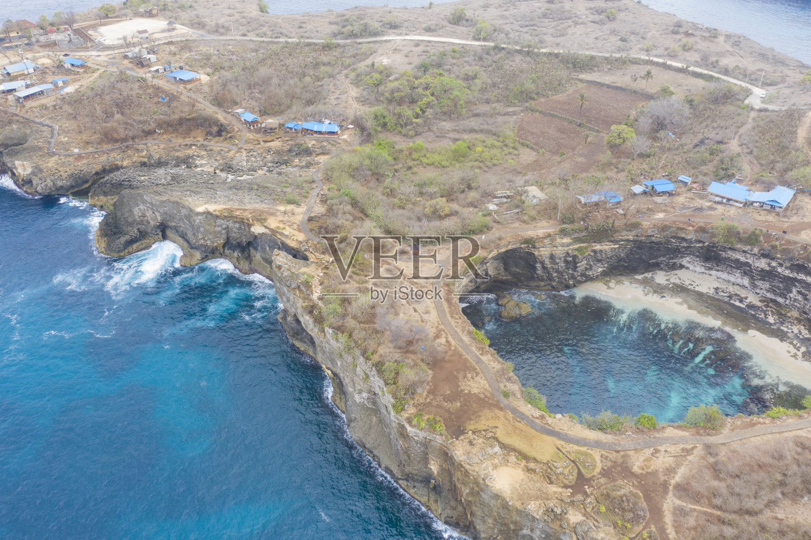 破碎海滩鸟瞰图，它是努沙佩尼达西南边缘的一个风景优美的海岸形成。该地点的标志是一个多山的岩石拱门，这是该地区的星星标志。也被当地人称为Pasih Uug。照片摄影图片