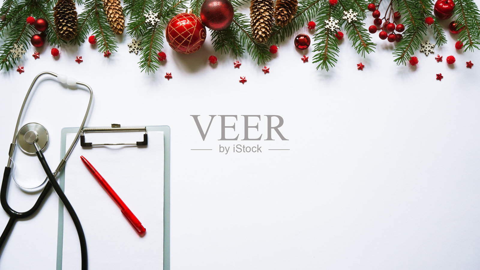 圣诞医学旗帜冷杉树枝，锥形，红球，雪花，听诊器和平板上的白色背景俯视图。Copyspace。7、医新年平平照片摄影图片
