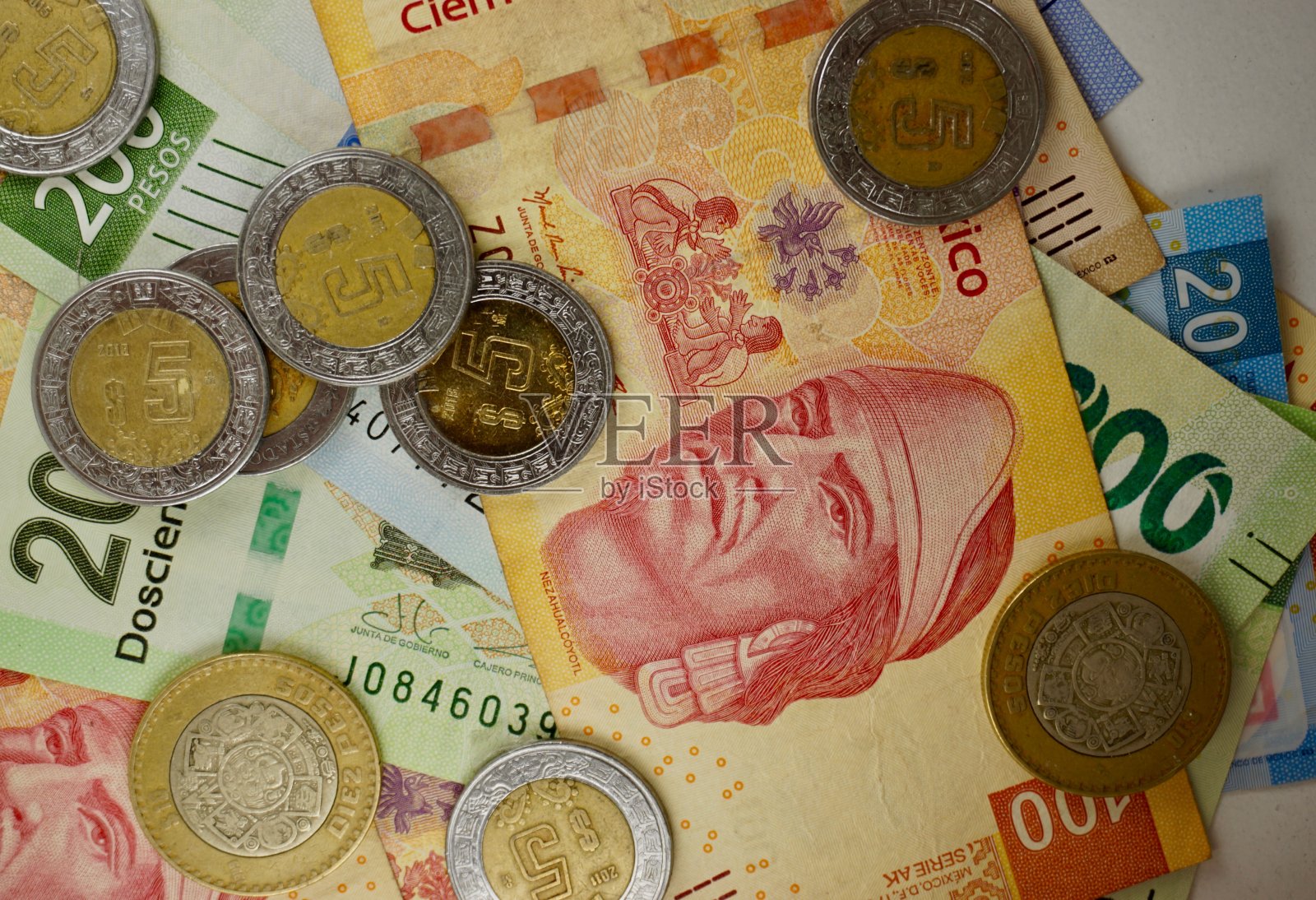 许多墨西哥比索纸币随机地散布在一个平面上照片摄影图片