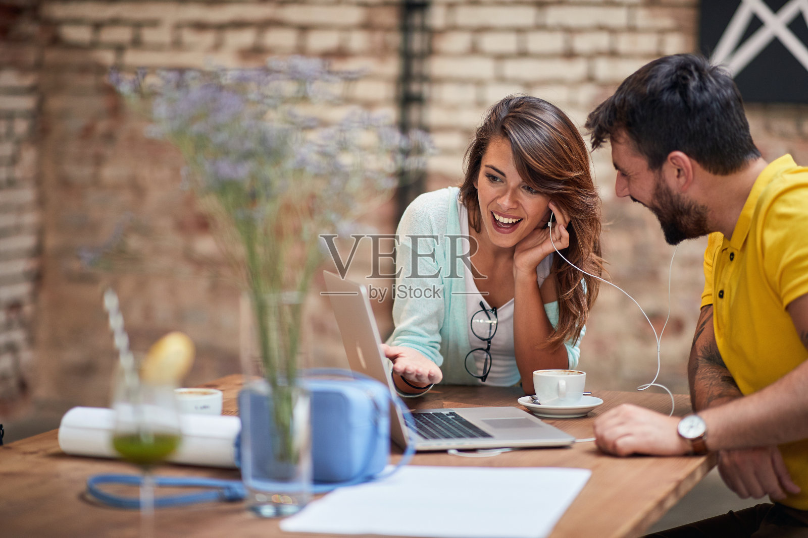 一对年轻夫妇在咖啡馆被笔记本电脑的内容惊呆了照片摄影图片
