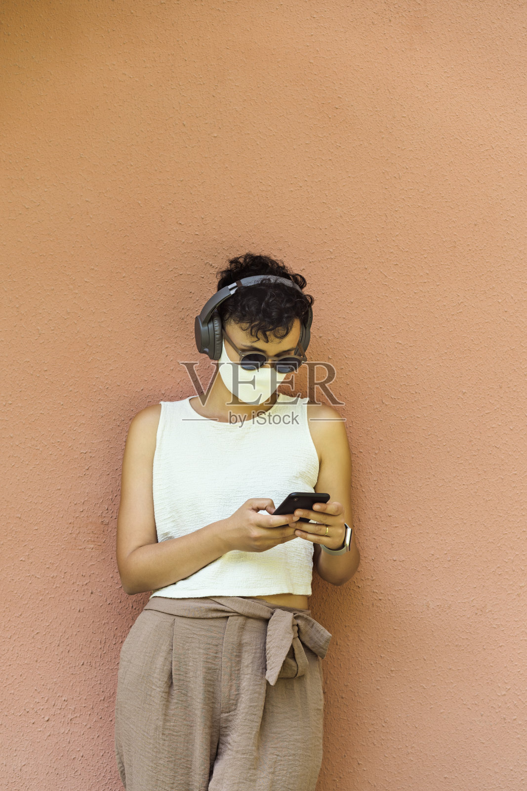 年轻女子戴着防护面具使用手机照片摄影图片