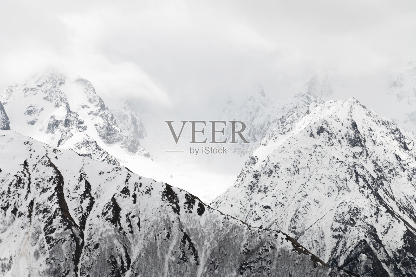 极简主义的景观，雪山山顶和冰川在云。北高加索和喜马拉雅山景观照片摄影图片